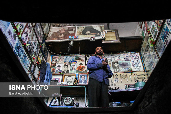 عکس منتخب سال - مهرماه - یکی از تعمیرکاران کوهدشتی مغازه خود را به عکس شهدا مزین کرده است.